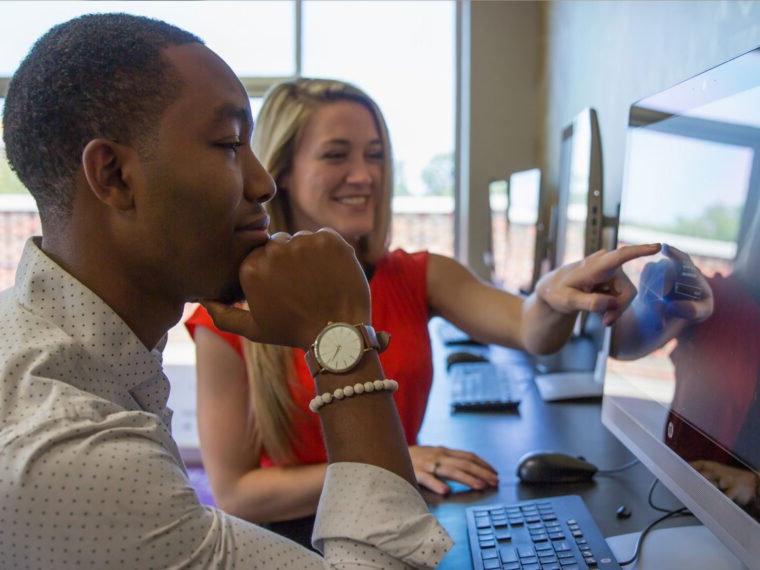 HSU students sitting at a computer talking